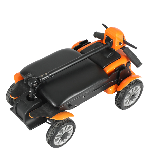 A compact orange and black folding mobility scooter with four wheels and a seat.