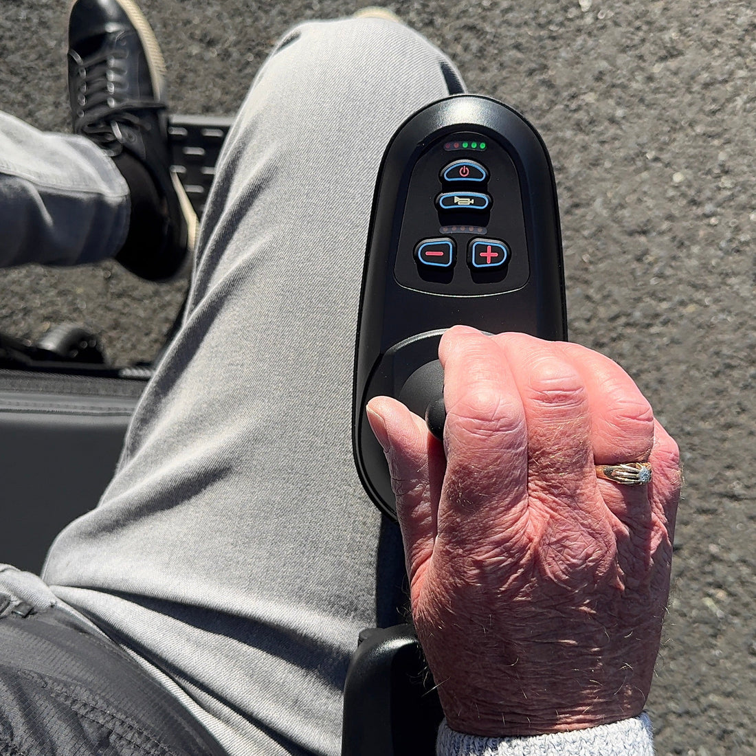 Person using a scooter with control panel on a road