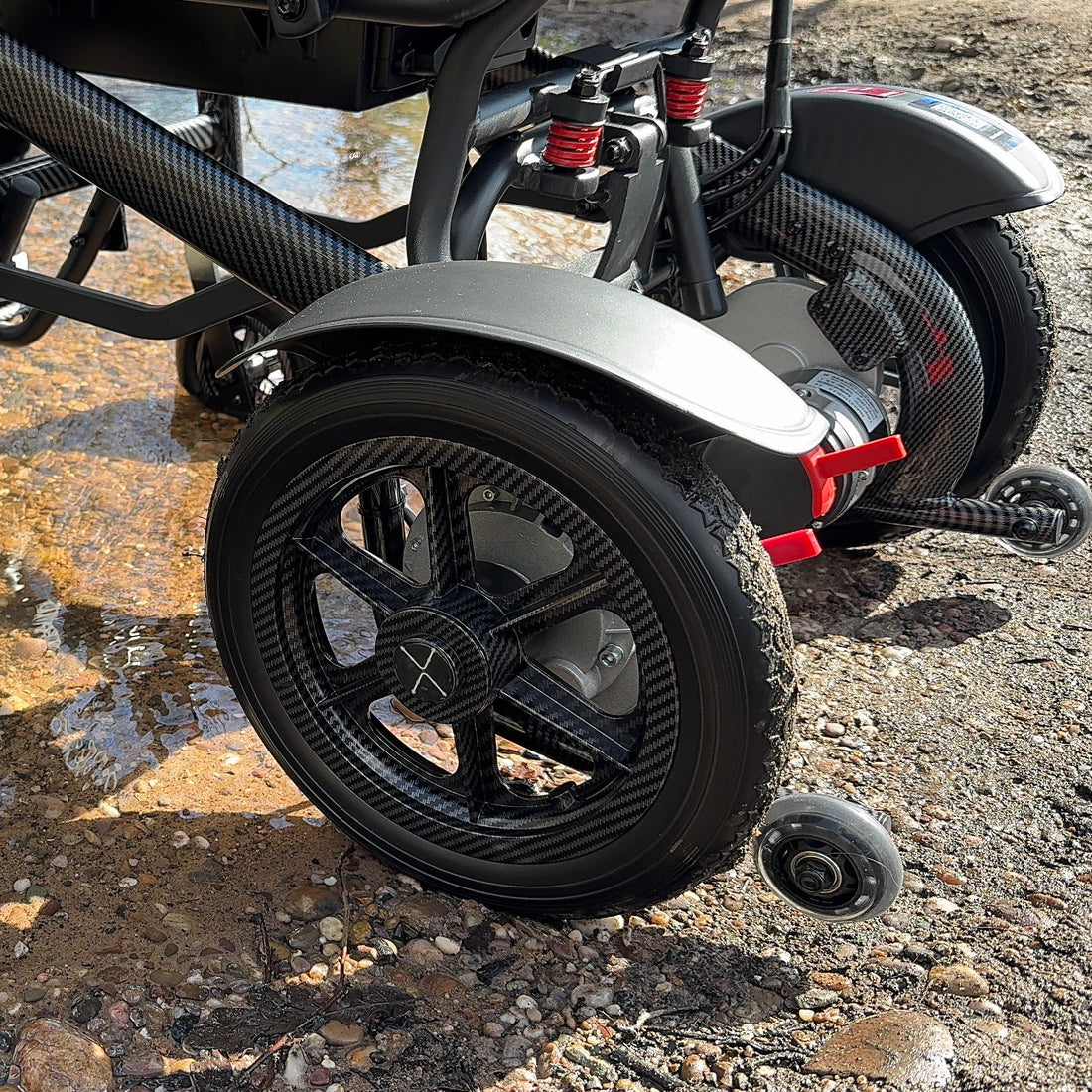 Person using a Electric wheelchair on a rocky surface