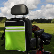 A green and black splash scooter bag attached to the back of a mobility scooter, set against an outdoor backdrop.