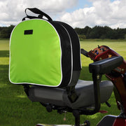 A high visibility green and black scooter bag attached to the back of a mobility scooter, set against an outdoor backdrop.